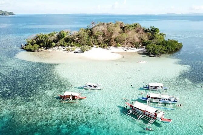 Full Day Coron Super Ultimate Tour - CYC Beach: white sand, turquoise water, and limestone shapes